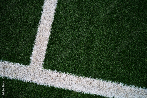 Artificial green grass football / soccer field / pitch & white stripe - close up