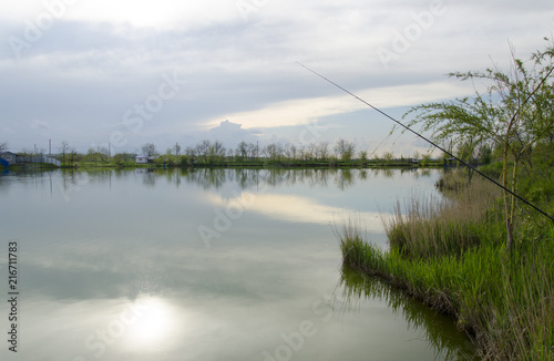 Fototapeta Naklejka Na Ścianę i Meble -  Beautiful lake view with fishing rod
