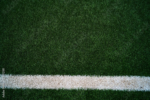 Artificial green grass football / soccer field / pitch & white stripe - close up