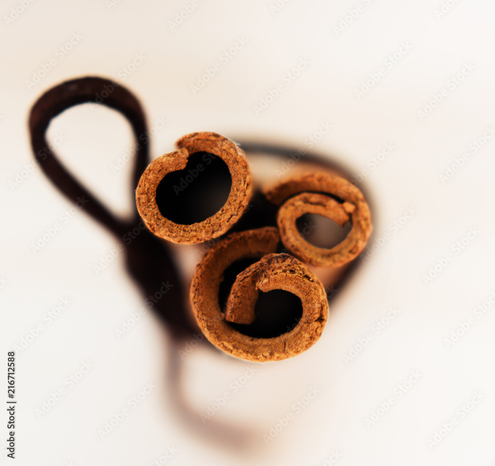 Cinnamon with brown ribbon. Closeup on wooden background Cinnamon with brown ribbon. Closeup on wooden background