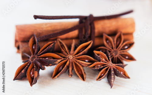 Cinnamon with brown ribbon. Closeup on wooden background