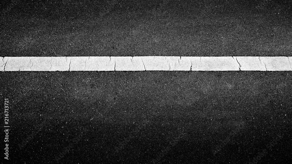 Fototapeta premium white paint line on black asphalt. space transportation background