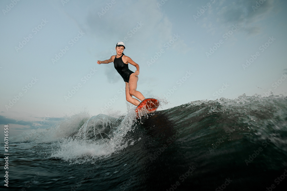 Woman riding on the wakesurf on the bending knees Woman riding on the wakesurf on the bending knees