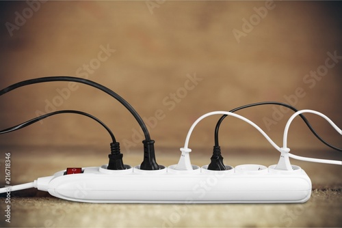 Socket strip and connected plugs on background