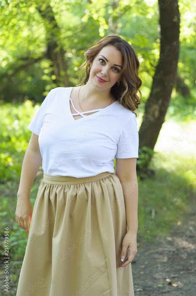 The happy Russian woman walks in the wood in the summer. The happy Russian woman walks in the wood in the summer.