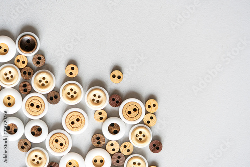 Wooden buttons set collection, on a gray light background. Soft focus, the space for the text is diagonalized. photo