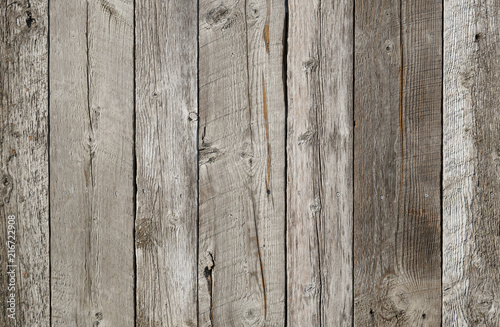 Rustic weathered wood surface with long boards lined up. Wooden planks on a wall or floor with grain and texture. Multicolor background with light bleached flat neutral tones.