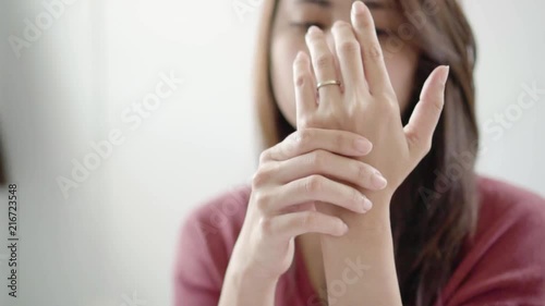 Slow motion young asian woman suffering from pain in palms.