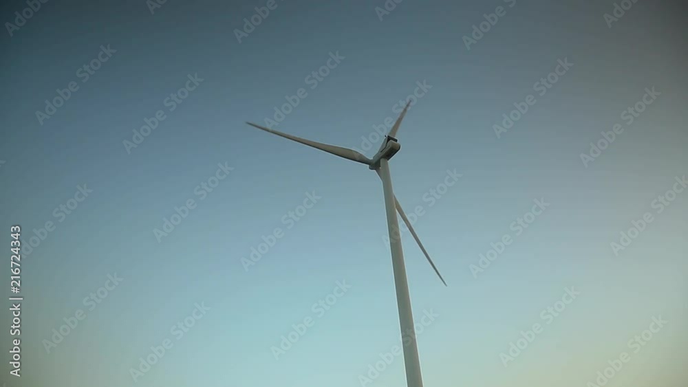 Wind mill spinning in the morning light. Copy space