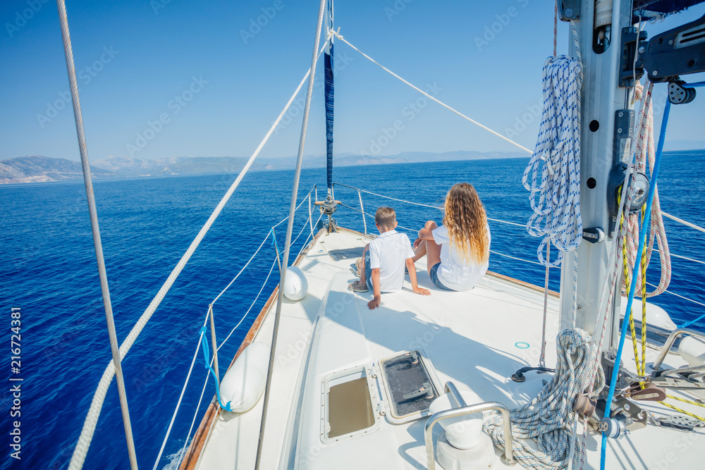 Boy with his sister on board of sailing yacht on summer cruise. Boy with his sister on board of sailing yacht on summer cruise.