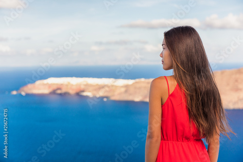 Santorini greece travel luxury destination Asian woman beauty at Oia landscape background. Tourist girl on holiday.