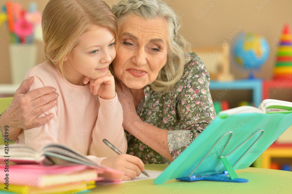 grandmother and granddaughter doing homework grandmother and granddaughter doing homework