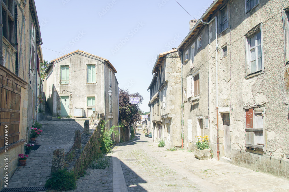Streets and buildings of medieval french old town in summer on a sunny day