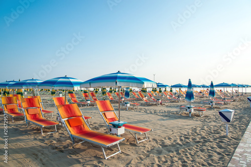 Fototapeta Naklejka Na Ścianę i Meble -  Umbrellas and chaise lounges on the beach of Rimini in Italy