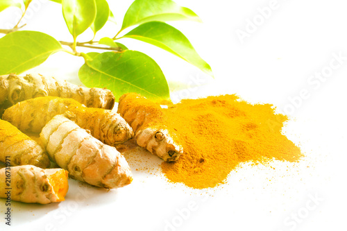 Turmeric roots and powder isolated on white photo