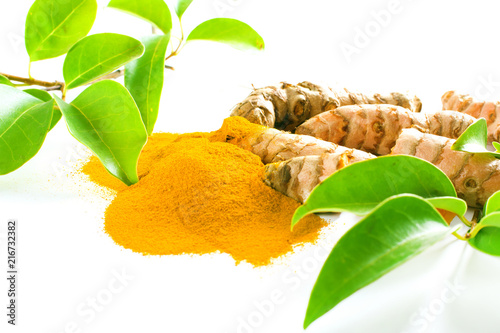 Turmeric roots and powder isolated on white photo