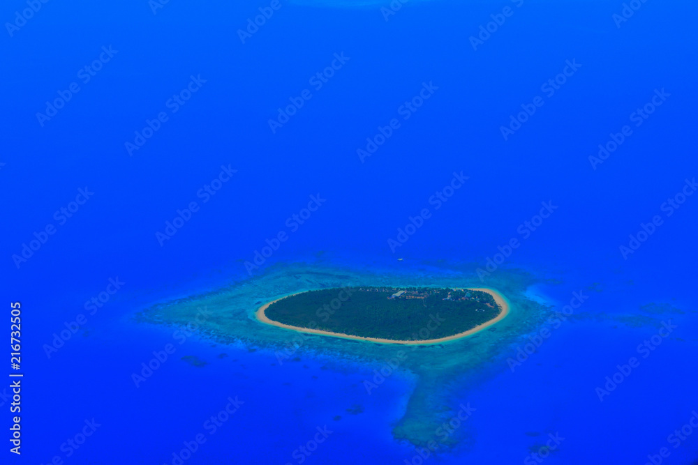 A tropical island in the middle of the ocean. A tropical island in the middle of the ocean.
