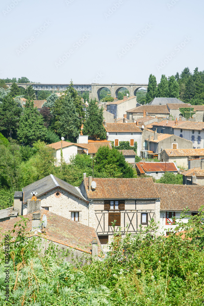French countryside summer landscape with tile roofs and flourishing nature