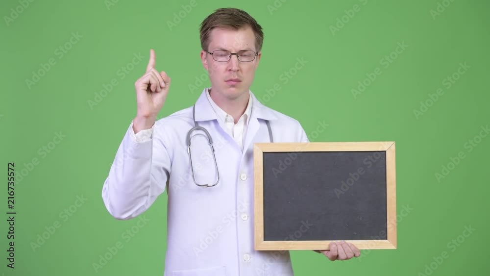 Man Doctor Holding Empty Blackboard With Copyspace