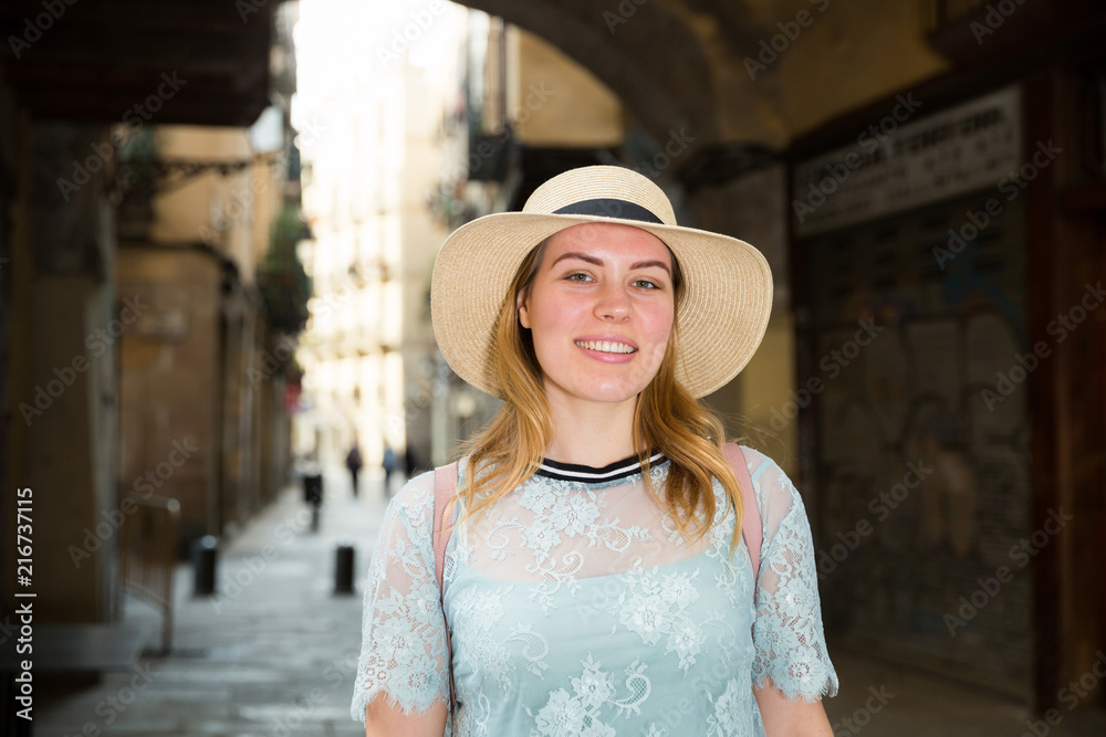 Young woman tourist in hat in historical city center outdoors