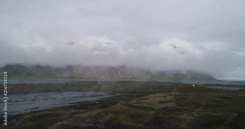 aerial drone view of stokksnes and vestrahorn covered in clouds in iceland aerial drone view of stokksnes and vestrahorn covered in clouds in iceland