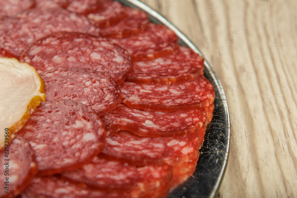 Sausage cuts of different varieties on a plate. Sausage cuts of different varieties on a plate.