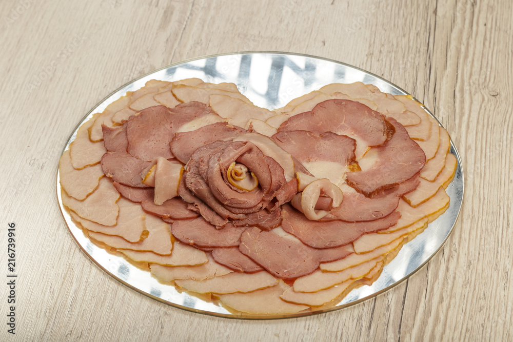 Fototapeta premium Sausage cuts of different varieties on a plate.