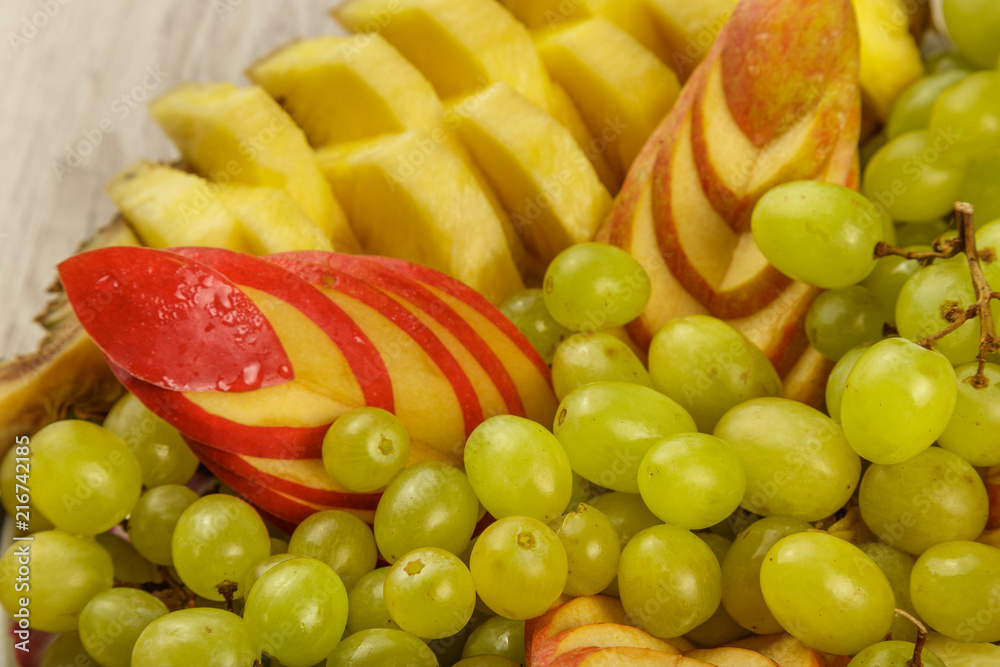 Very nice and artistically sliced fruits on a platter.