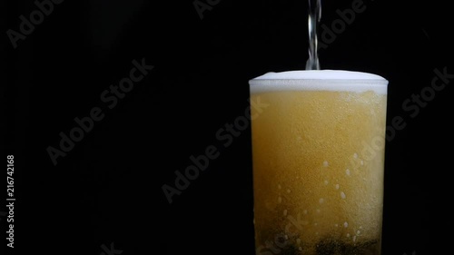 Wallpaper Mural Beer is pouring into glass with foam sliding down side of beer glass Torontodigital.ca