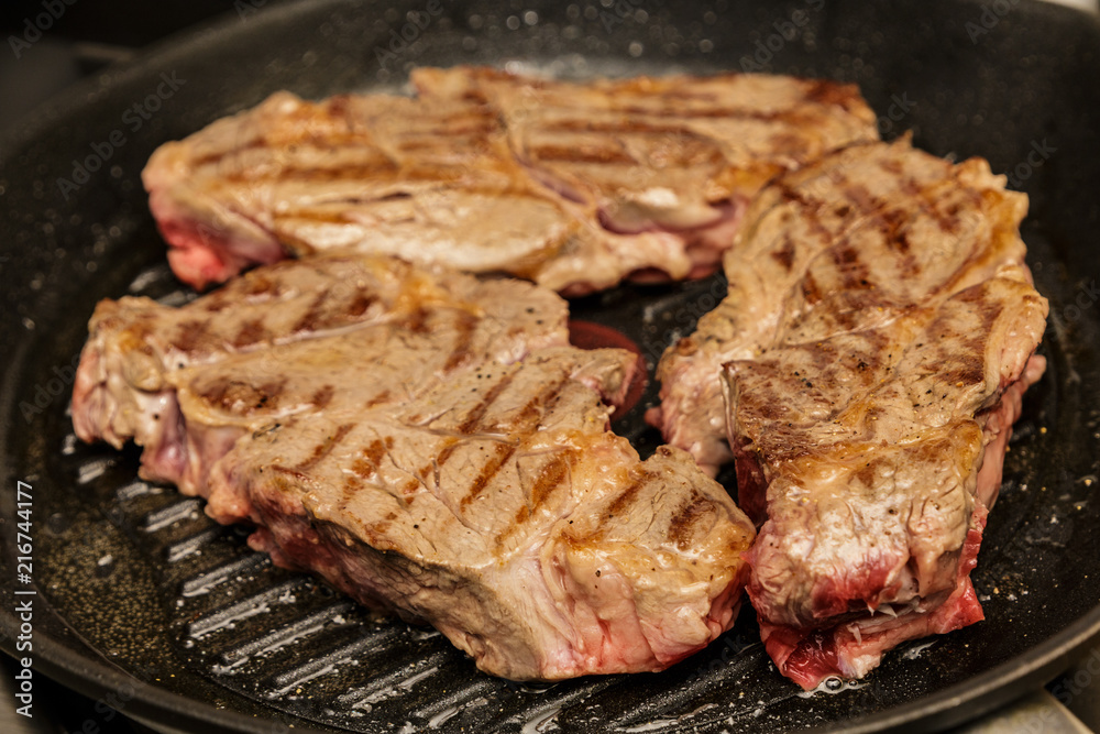 Three Chuck Steaks Turned on Grill Three Chuck Steaks Turned on Grill