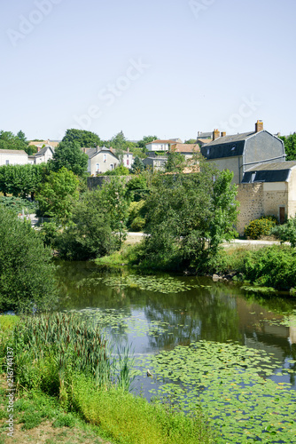 French countryside summer landscape with tile roofs and flourishing nature