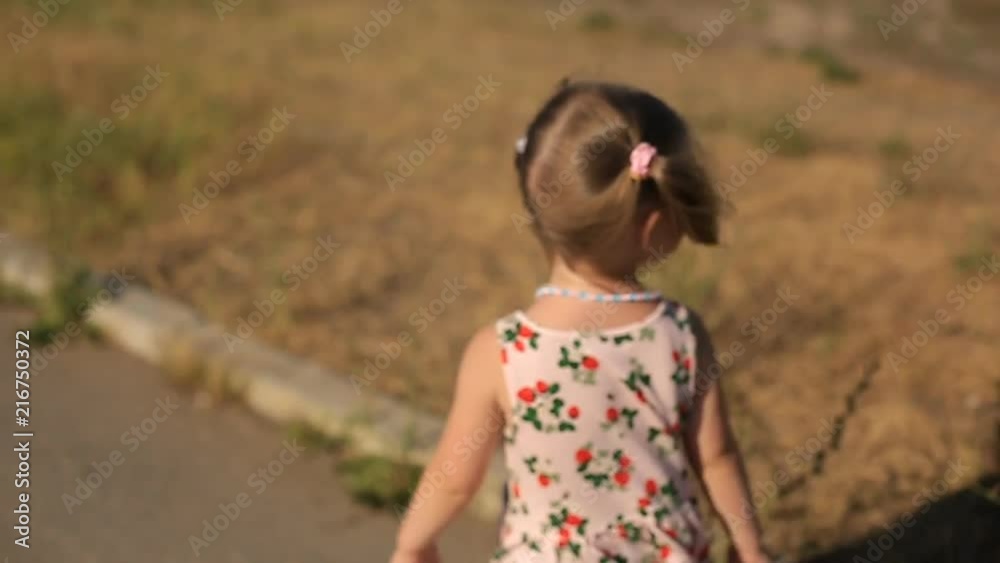 two year old girl running on the track in the Park on a summer day two year old girl running on the track in the Park on a summer day