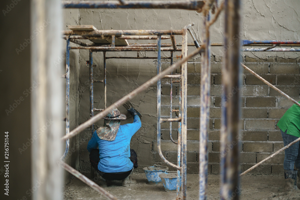 Worker labor building wall with concrete cement Worker labor building wall with concrete cement