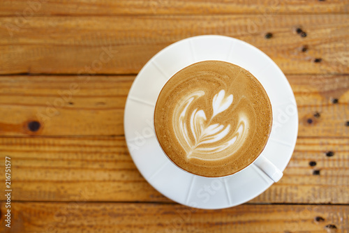 Cup of coffee with latte art pattern milk foam