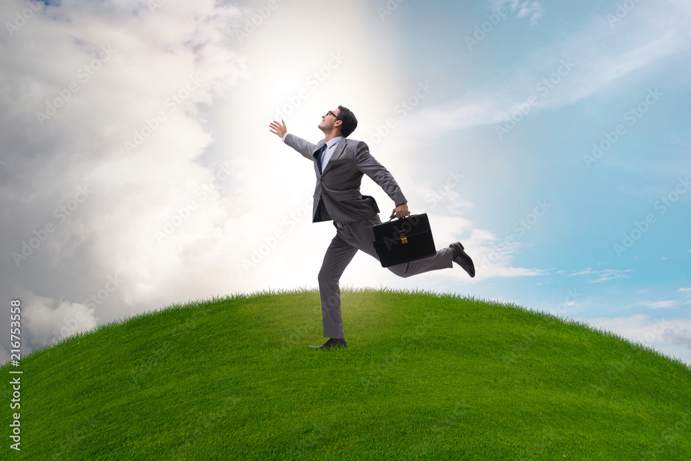 Happy businessman running towards his goal Happy businessman running towards his goal