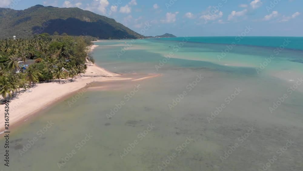 Flight over the water along the beach line on a bright sunny day Flight over the water along the beach line on a bright sunny day