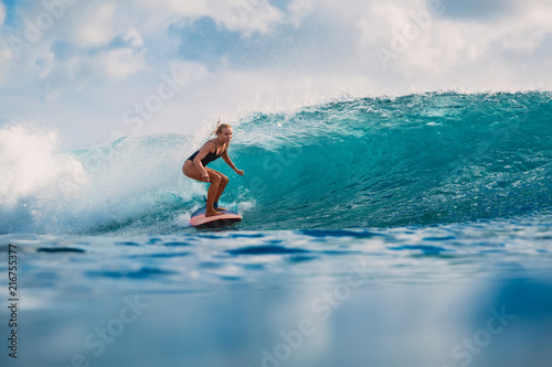 Photography Attractive woman on surfboard during surfing