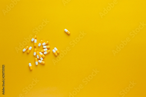 hand picked yellow pill capsule