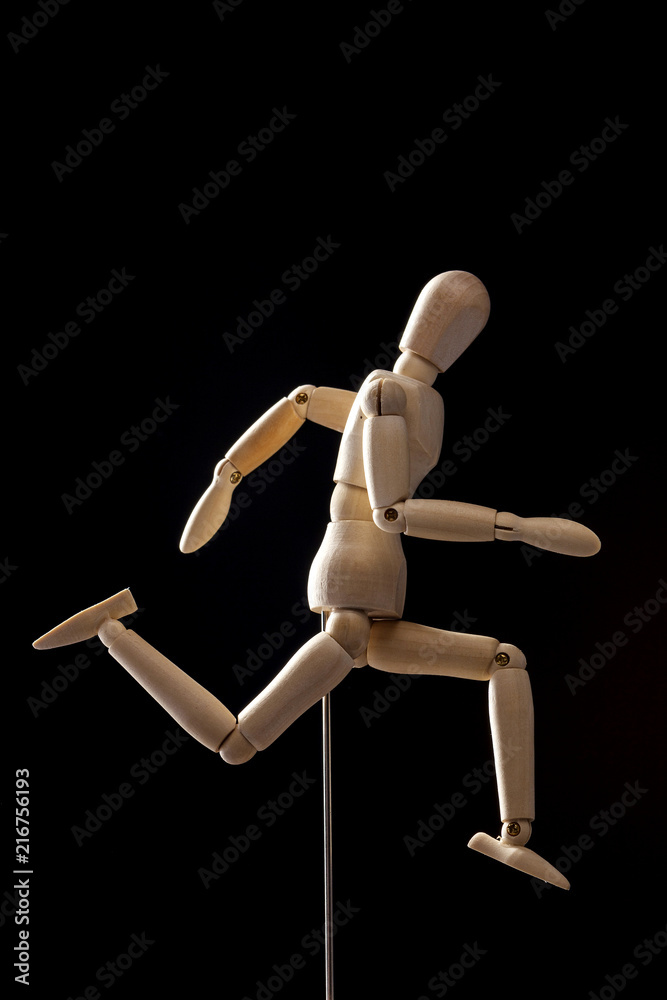 wood Mannequin, human run on the black background. wood Mannequin, human run on the black background.