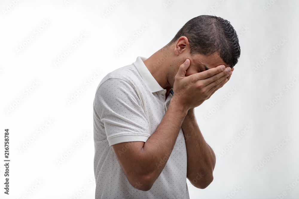 Fototapeta premium Man covering his face with his hands