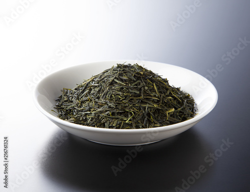 green tea leaves isolated on black background