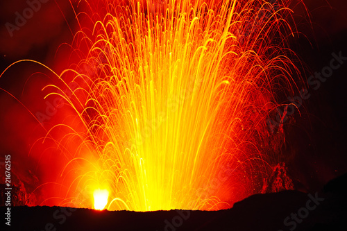 a volcanic eruption at night.