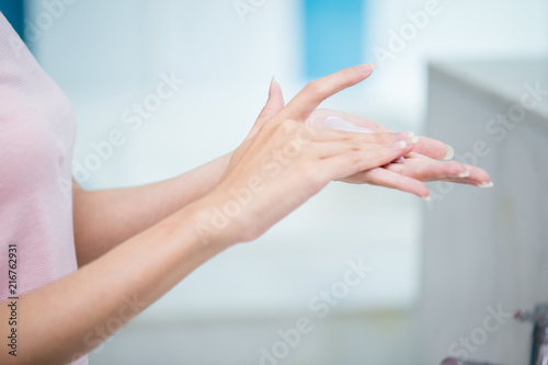 woman apply lotion on hands © ryanking999