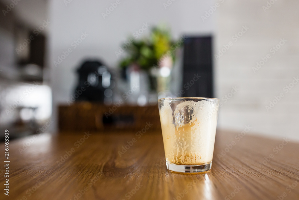 empty dirty espresso coffee cup on kitchen counter with interesting perspective, with cup in focus and blurred background empty dirty espresso coffee cup on kitchen counter with interesting perspective, with cup in focus and blurred background