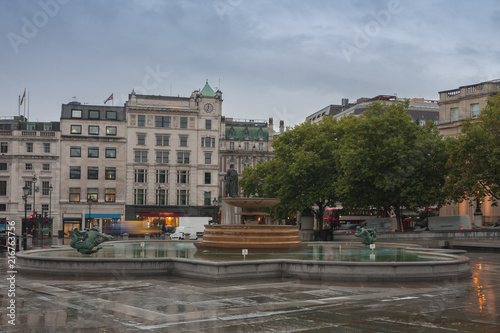 The fountain on Trafalgar square in rainy early morning time in London, United Kingdom
