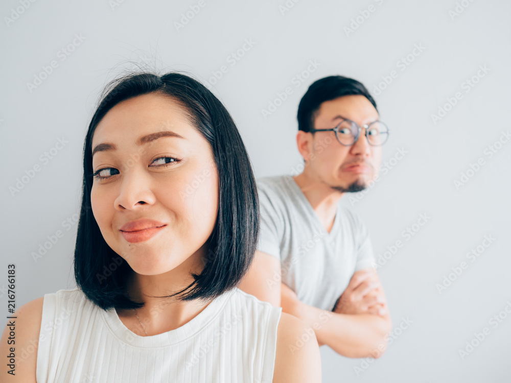 Happy Asian wife and angry loser husband.