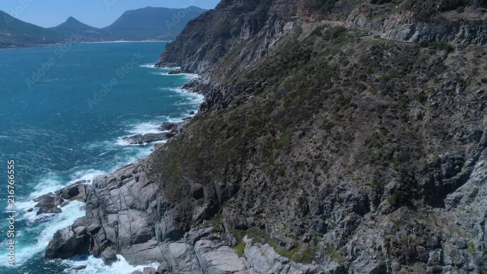 Drone flying above dramatically rugged coastline of Cape Peninsula - Chapman's Peak Drive, South Africa Drone flying above dramatically rugged coastline of Cape Peninsula - Chapman's Peak Drive, South Africa