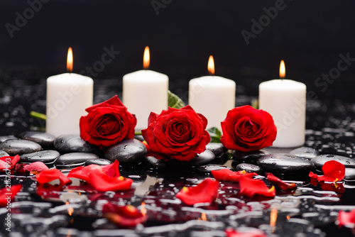 Still life with red rose  petals with candle and therapy stones   