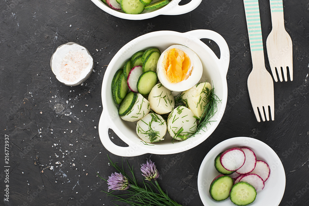 Potato salad farmer market with fresh vegetables cucumber, radish and organic eggs with dill and chives onions. Top View. Potato salad farmer market with fresh vegetables cucumber, radish and organic eggs with dill and chives onions. Top View.