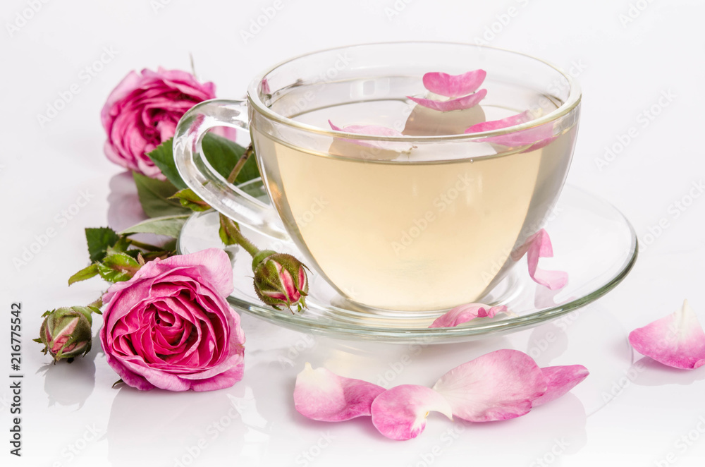 Glass cup of Tea with roses and petals Glass cup of Tea with roses and petals
